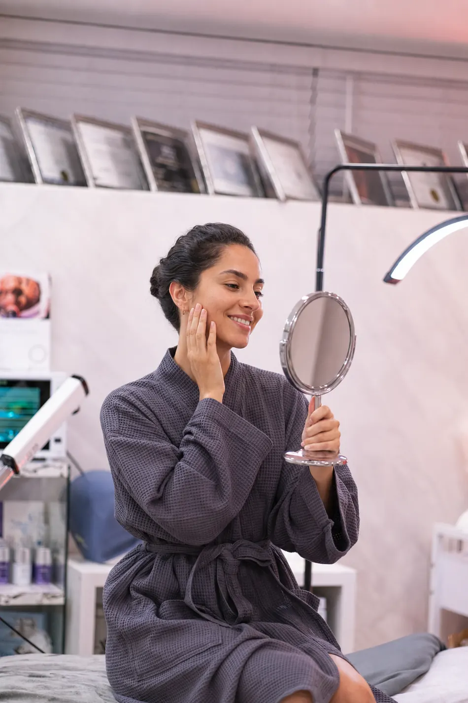 Client admiring radiant, glowing skin in the mirror after an Oxygen Facial
