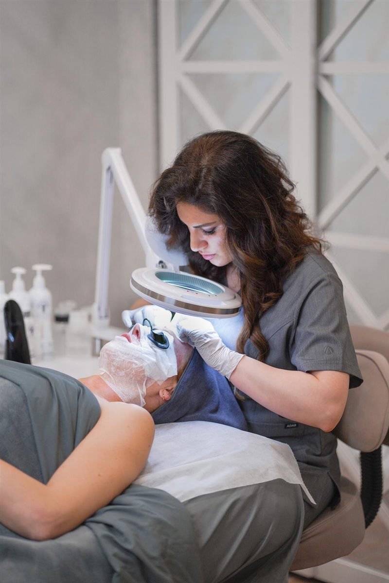 Esthetician performing extractions during a Deep Cleansing Facial